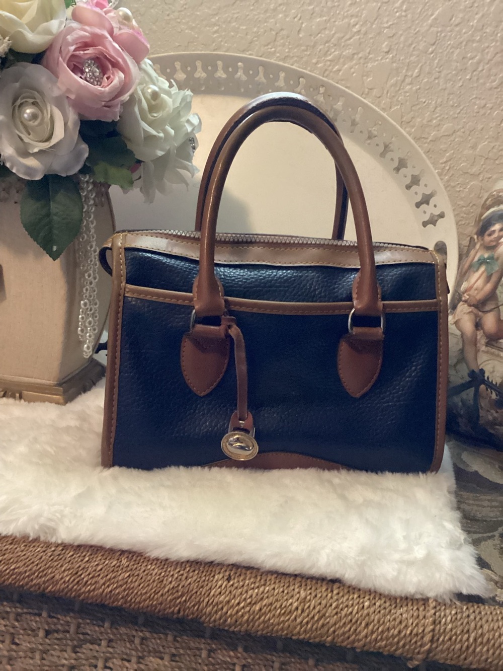 Dooney & Bourke  Navy Pebbled Leather Satchel with Brown Trim.